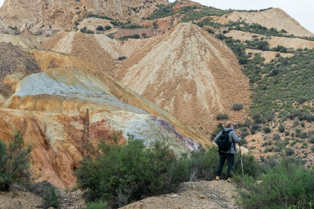 Man walking through the abandoned Mines of MazarrÃ³n. Murcia region. Spain