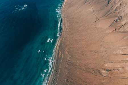 Woman standing on Famara cliff, Lanzaroteの写真素材