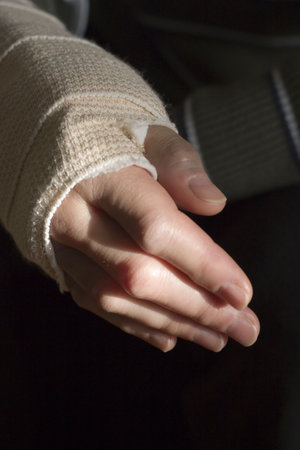 Woman holds bandaged wrist.の写真素材