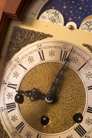 Closeup of antique clock face: deadline, late for work, time running out.