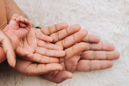 Family hands are stacking hands under the babys handの写真素材