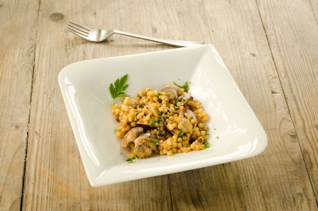 Durum wheat semolina cooked with clams, typical pasta from Sardinia, Italyの写真素材