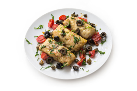 Boiled cod fillets with black olives and tomatoの写真素材