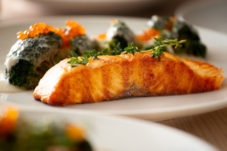 Salmon steak on a white plate. Grilled salmon with broccoli. Salmon with vegetables. Proper nutrition.の写真素材