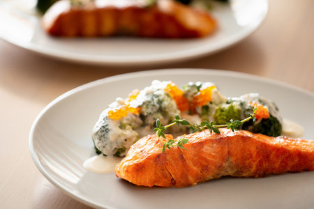 Salmon steak on a white plate. Grilled salmon with broccoli. Salmon with vegetables. Proper nutrition.の写真素材