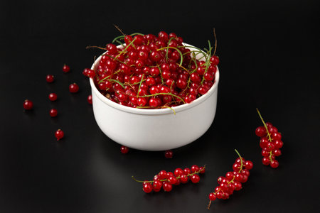 red currant branches on a dark background close-up copy space. Useful dietary product.の写真素材