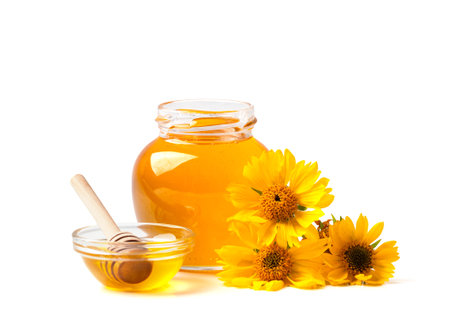 Honey bee with honey dipper and flower isolate on white background, bee products by organic natural ingredients conceptの写真素材