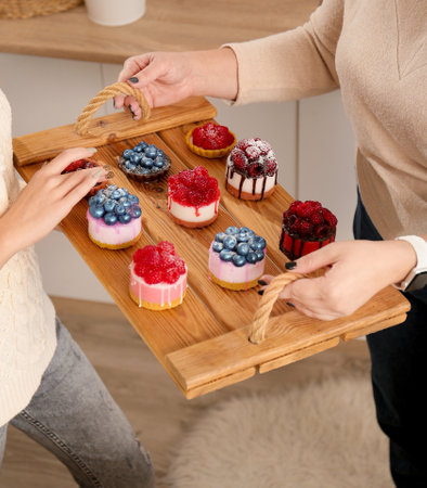 handmade soap. Home made soap look like cake with berries on light background. Natural homemade cosmetics and handmade soaps concept. The girl is holding a homemade muffin in her handsの写真素材
