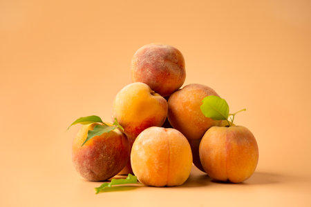 A pile of fresh peaches on a brown background. A handful of raw peaches on a brown background. Useful dietary product.の写真素材