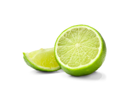 Half and slice of juicy fresh lime isolated. Lime on a white background. Cut green lime isolated.の写真素材