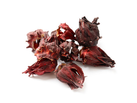 Hibiscus tea on a white background close-up. Dry flowers of red hibiscus on isolation. A handful of hibiscus for making tea. Ingredients for preparing a healthy drink.の写真素材