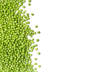 Fresh green peas are scattered on a white background, top view, copy space. Shelled grains of organic green peas on a white background. Vegetable protein, healthy products.の写真素材