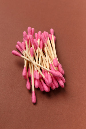 Bamboo cotton swabs buds sticks on a brown background, top view. Eco-friendly items for hygiene, makeup, medicine.の写真素材