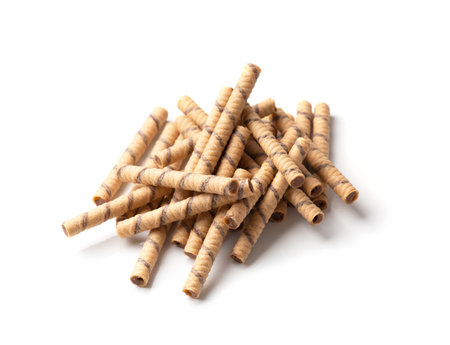 Crispy wafer rolls with chocolate cream are folded into a beautiful pile on a white background. Pile of crispy wafer sticks with chocolate filling isolated.の写真素材