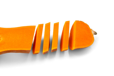 Ripe sweet butternut squash cut into slices, isolated on a white background. Cut orange pumpkin in the shape of a bottle.の写真素材