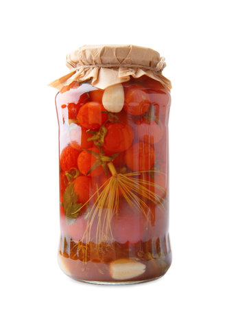 Canned cherry tomatoes in a closed glass jar isolated on a white background, close-up. Pickled tomatoes with spicesの写真素材