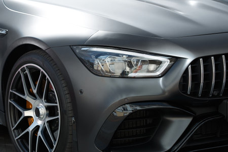 Headlights and front wheel of a modern car close-up, elegant auto design.の写真素材