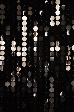 Abstract background with shimmering and shiny silver metal plates discs or sequins. Wall with a 3D...