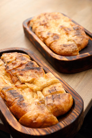 Fresh pita bread on a wooden board on a table. Lavash cooked in the oven.