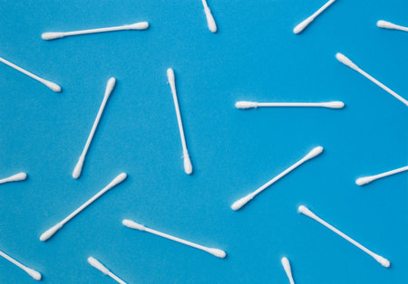 Cotton swabs buds sticks on a blue background. The concept of cleansing, hygiene, medicine, skin...
