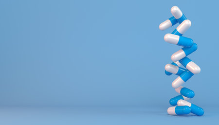 3d rendering of some capsules in blue and white - Medicine on blue background.の写真素材