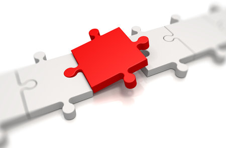 Focus on a red puzzle pieces over white backgroundの写真素材