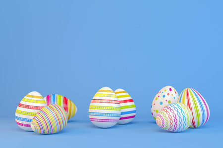 3d render of eight colorful, painted Easter eggs on blue backgroundの写真素材