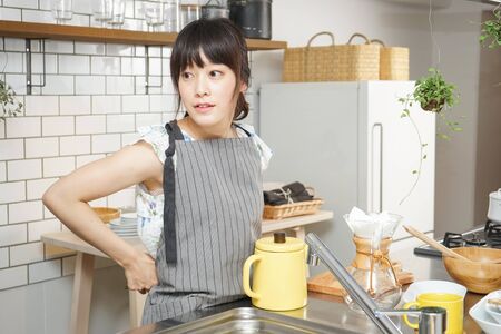 Young woman making some coffeeの写真素材