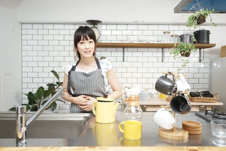 Young woman making some coffeeの写真素材