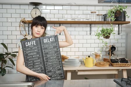 Young woman making some coffeeの写真素材