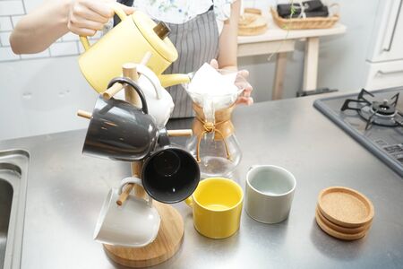 Young woman making some coffeeの写真素材