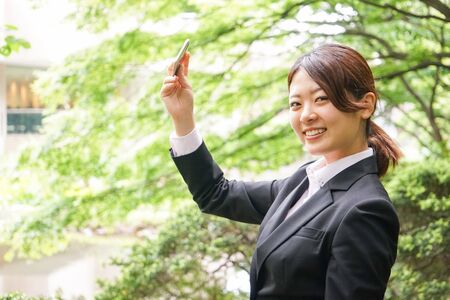 Young businesswoman taking a selfie with smileの写真素材