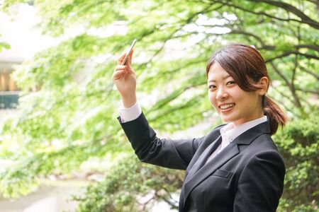 Young businesswoman taking a selfie with smileの写真素材