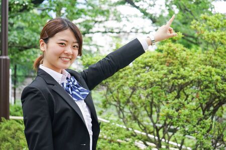 Student pointing to something in uniformの写真素材