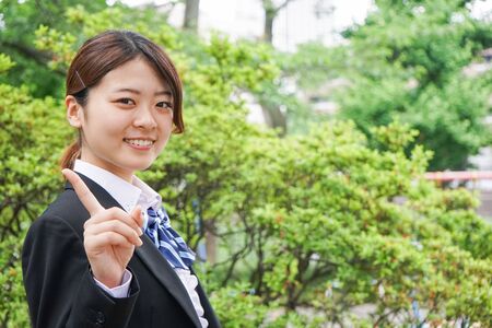 Student pointing to something in uniformの写真素材