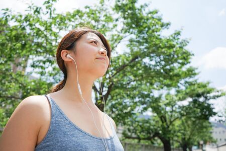 Young woman runnning with listening to musicの写真素材