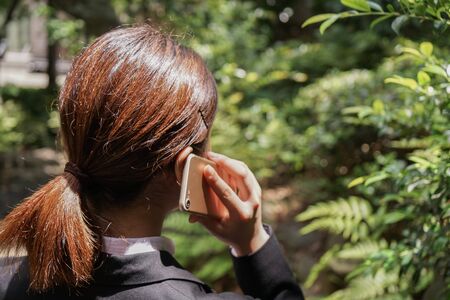 Young businesswoman talking with smartphoneの写真素材