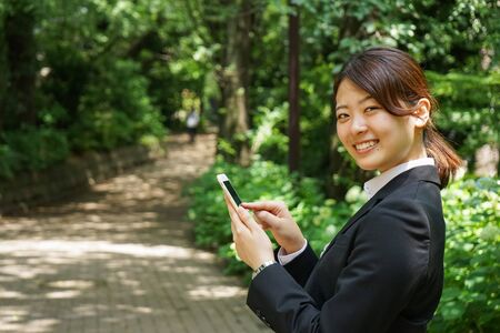 Young businesswoman using smartphoneの写真素材