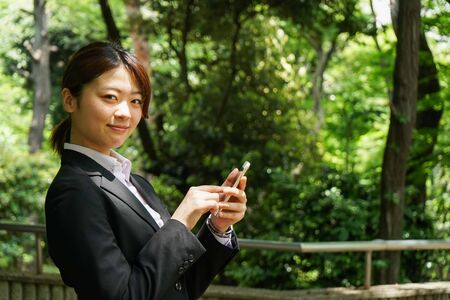 Young businesswoman using smartphoneの写真素材