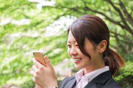 Young businesswoman using smartphoneの写真素材