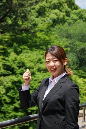 Young businesswoman thumbs upの写真素材