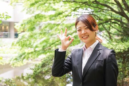 Young businesswoman thumbs upの写真素材