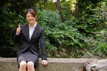 Young businesswoman thumbs upの写真素材