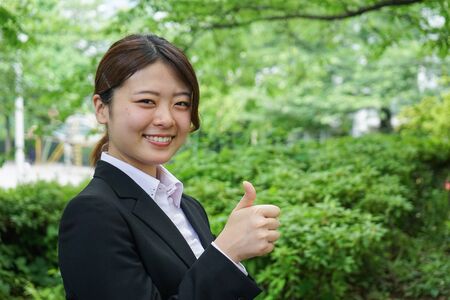 Young businesswoman thumbs upの写真素材