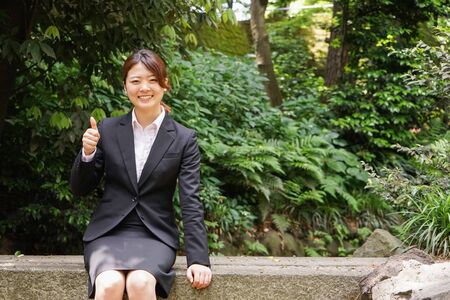 Young businesswoman thumbs upの写真素材