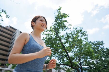 Young woman running in the cityの写真素材