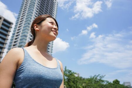 Young woman running in the cityの写真素材