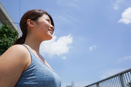 Young woman running in the cityの写真素材