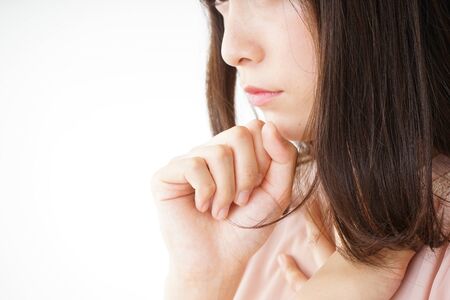 Young woman getting a cough because of coldの写真素材