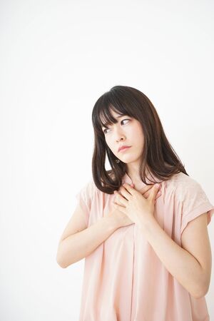 Young woman suffering poor health because of a hangoverの写真素材